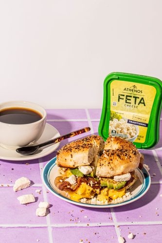 Athenos Feta Breakfast Sandwich
Active time: 10 minutes 
Total Time: 15 minutes
Serves 1

Description: Everything is truly better with feta! Step up your classic breakfast sandwich flavors with creamy feta crumbles.

Ingredients: 

1 everything bagel, lightly toasted
½ tsp olive oil
2 eggs, scrambled (see directions below)
Kosher salt
Cracked black pepper
2 slices cooked bacon
½ avocado, sliced 
1-2 tbsp of Athenos Feta Block Cheese

Method: 

Cut everything into halves and lightly toast (or toast to your preference). 
In a small non-stick pan add in olive oil and heat in medium-low. Lightly whisk two eggs and then pour into a heated non-stick pan. With a rubber spatula, slowly and gently begin to turn the eggs over until they have cooked. Remove from heat and season with a sprinkle of kosher salt and cracked black pepper. 
Top toasted bagel, top with slices of bacon, eggs, avocado slices, and feta cheese crumbles. Cut down the center and enjoy.